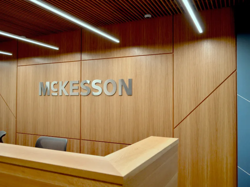 McKesson brushed-metal lobby letters on a wood wall