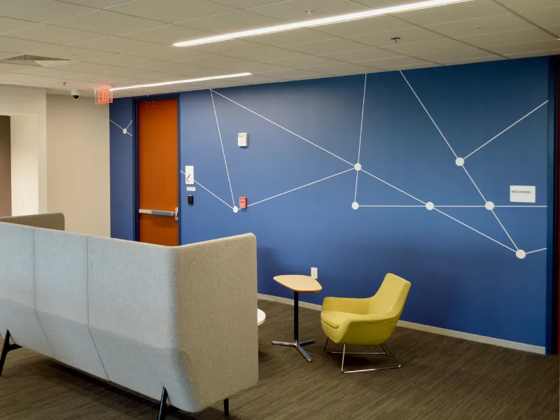 Office lobby with blue geometric wall graphic